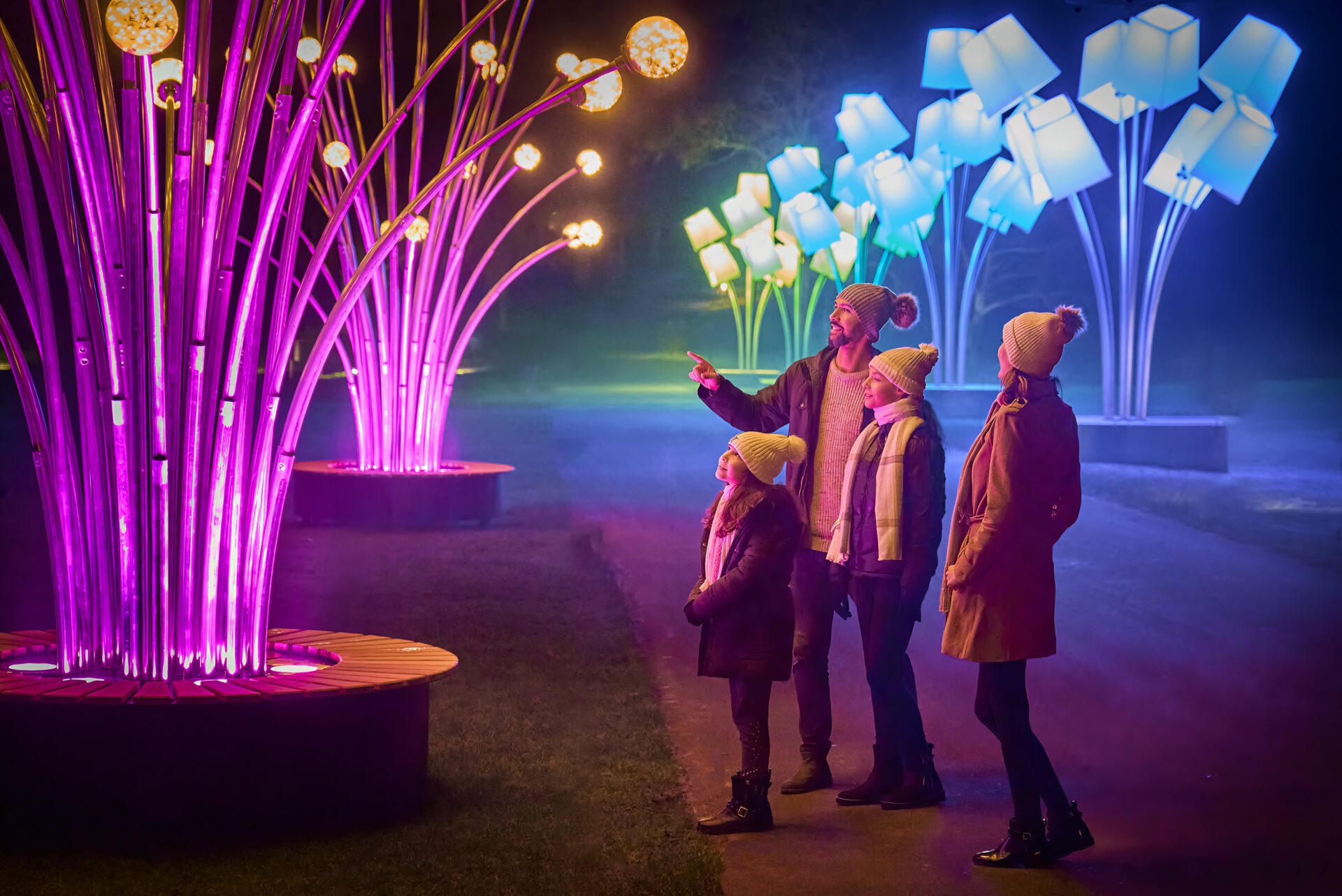 Family admiring the lights installation at Leeds Castle