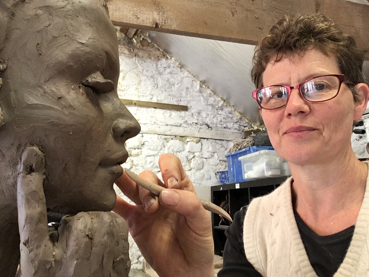 Sculptor Christine Baxter working on a female bust